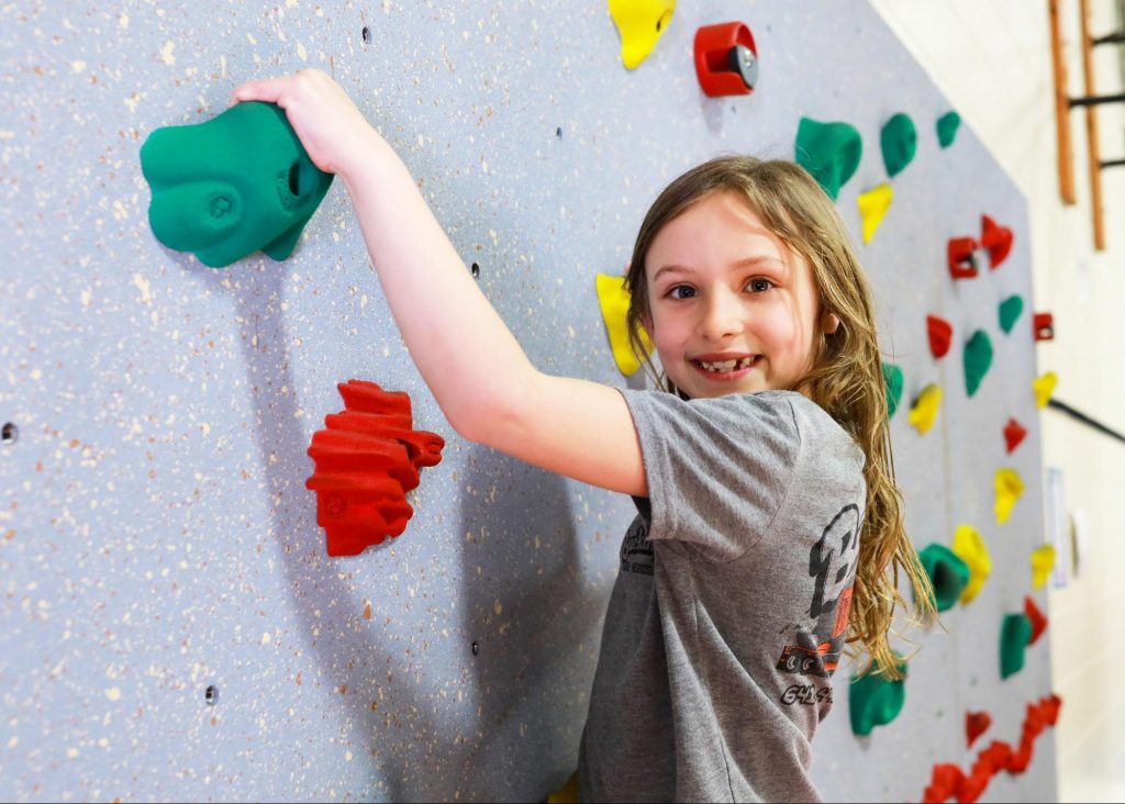 Elementary student on a climbing wall